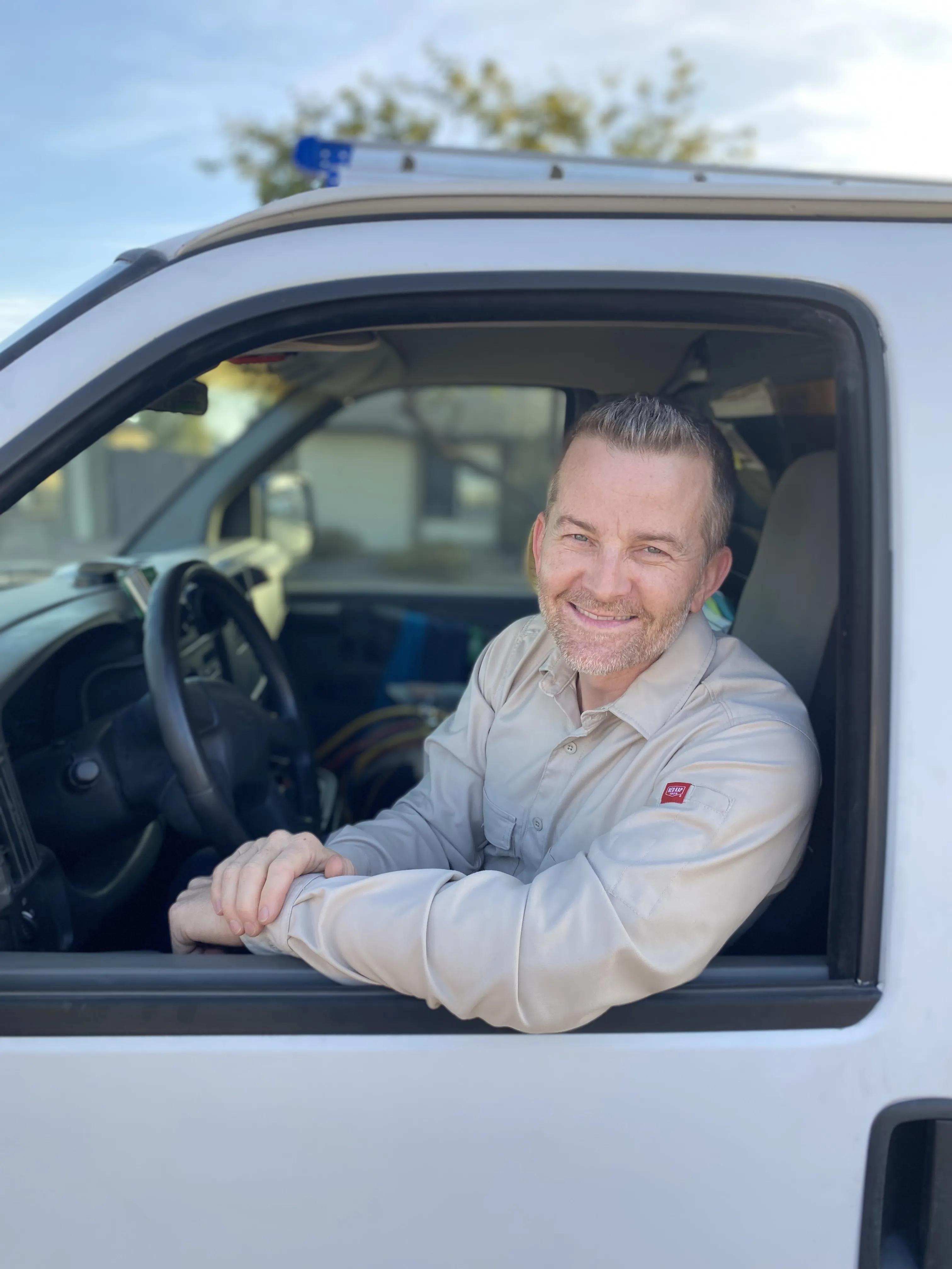 AC technician with service truck in Mesa, AZ